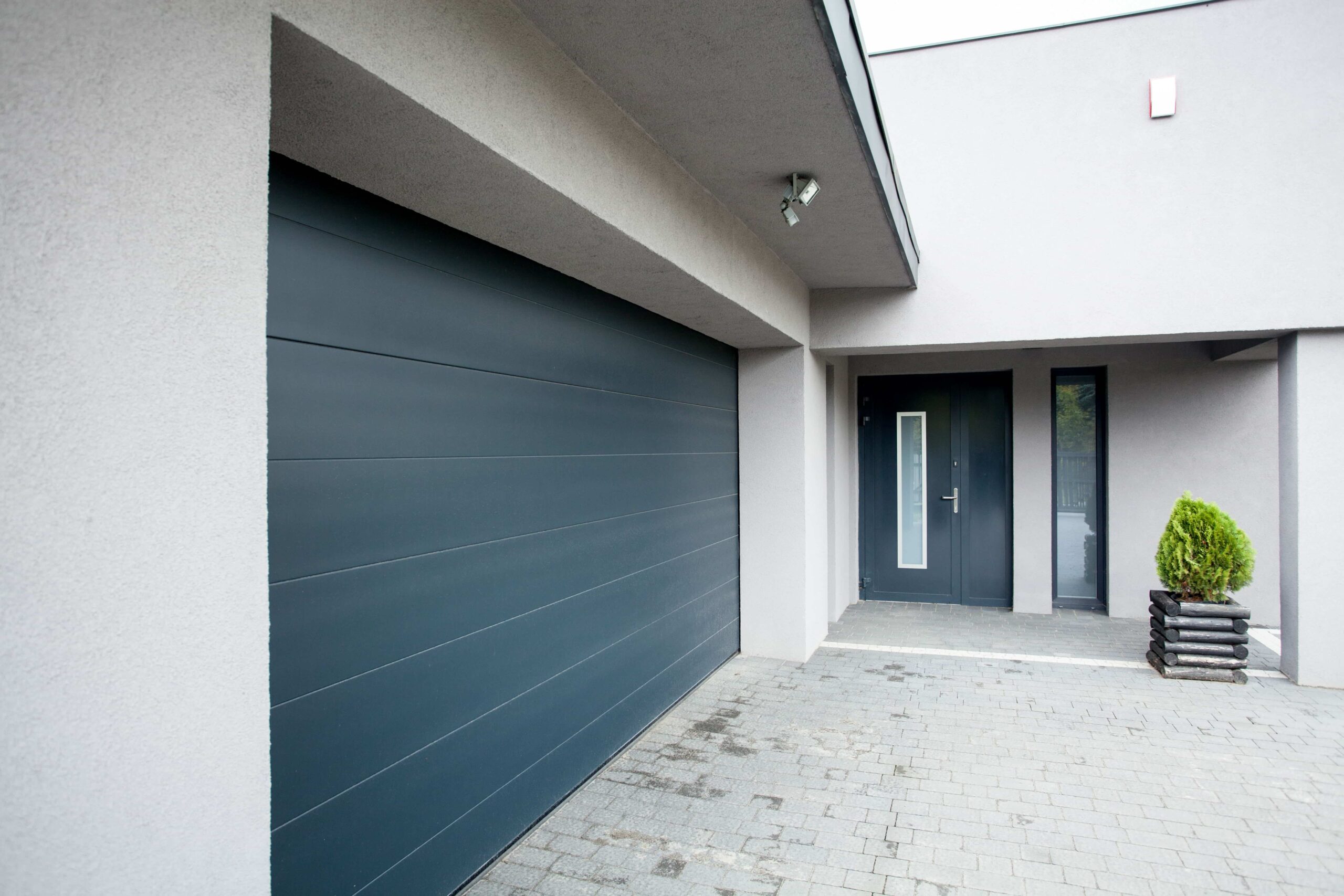 House with a garage door with flush panels